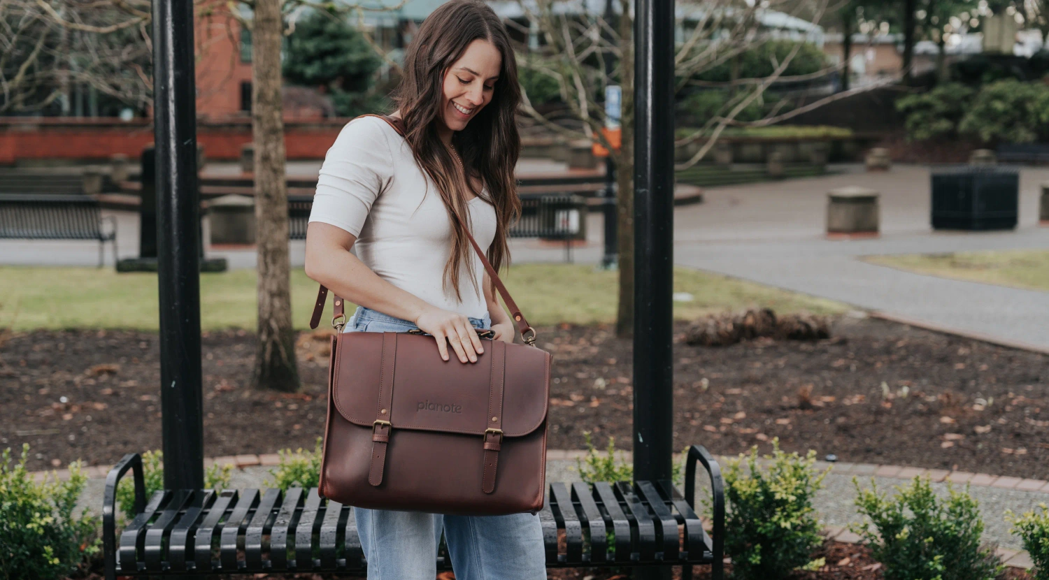 A woman carrying The Pianote BookBag, showcasing its fashionable and functional design.
