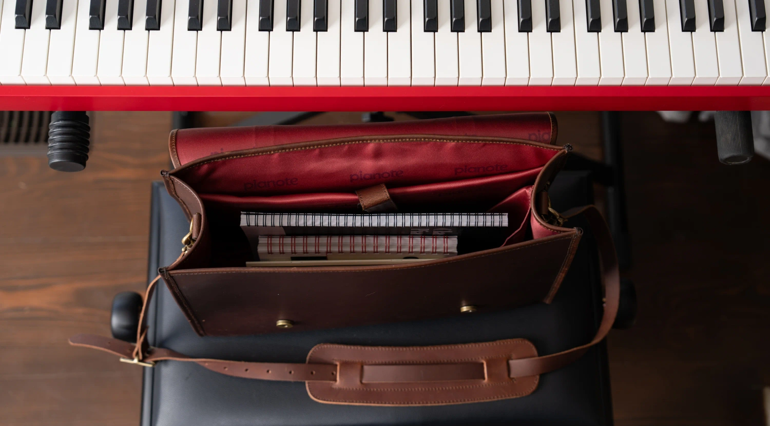 Stack of music sheets neatly organized inside The Pianote BookBag.