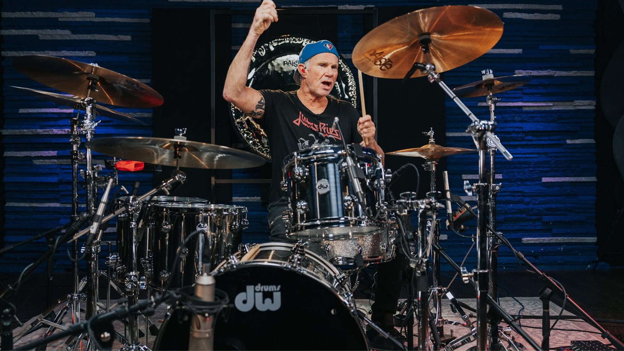 Drummer performing with a miked drum kit