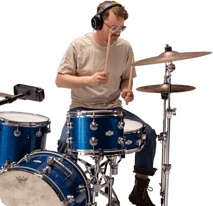 Drummer playing with headphones on